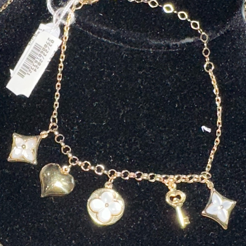 14 karat gold and Mother of pearl charm bracelet brand new with the tag